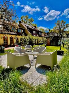 a group of chairs and tables in front of a building at Fritz Aparthotel Potsdam in Potsdam