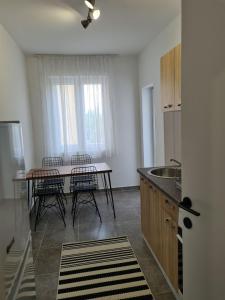 a kitchen with a table and chairs in a room at Serenity City Centre in Podgorica