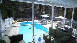 a view of a swimming pool from a house at Okanagan Saltwater Pool & Swimspa Oasis in Penticton