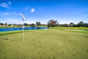 a golf course with a flag on the green at Orlando Vacation Rental with Yard and Pool Access in Orlando