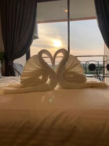 two wooden swans sitting on top of a bed at Heavenly place 777 on Mai Khao in Ban Mai Salae