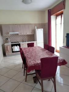 a kitchen with a table and chairs and a refrigerator at Annalisa house 134 in Naples