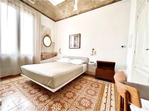 a bedroom with a large bed and a window at DOMUS ALERIA Deluxe Rooms in Sciacca