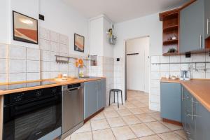a kitchen with blue cabinets and a counter top at Apartament Family - darmowy Parking, blisko centrum - by Kairos Apartments in Gliwice