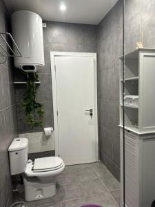 a bathroom with a toilet and a white door at Quiet Place in Machico