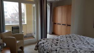 a bedroom with a bed and a chair and a window at Strandküsschen in Kühlungsborn