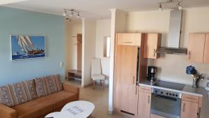 a living room with a couch and a kitchen at Strandküsschen in Kühlungsborn