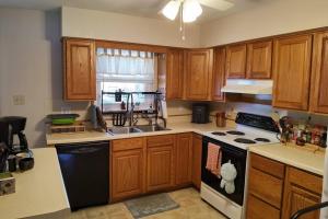 a kitchen with wooden cabinets and a stove top oven at Artistic Home in Lewisburg in Lewisburg