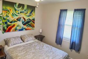 a bedroom with a bed and a painting on the wall at Artistic Home in Lewisburg in Lewisburg