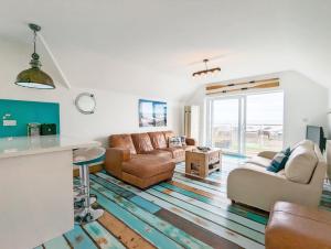 a living room with two couches and a table at Seaside in Selsey