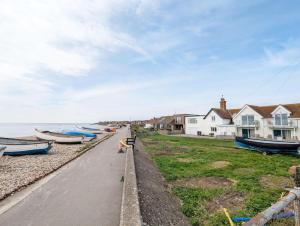 a group of boats parked on the side of a street at Seaside in Selsey