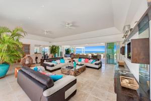 a large living room with couches and a table at Villa Ambiance in Marigot