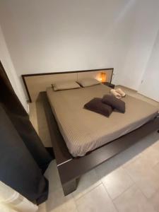 a bedroom with a bed with a lamp on it at Samothraki Belize Luxury Apartments in Samothraki