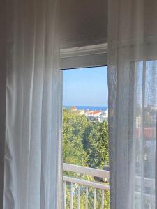 a window with a view of the ocean at Samothraki Belize Luxury Apartments in Samothraki