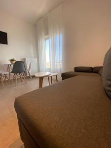 a room with a bed and a couch and a table at Samothraki Belize Luxury Apartments in Samothraki