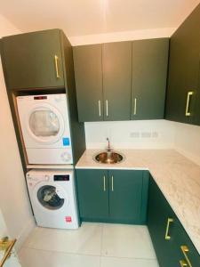 a kitchen with a washing machine and a washer at Farmhouse in Virginia County Cavan in Cavan