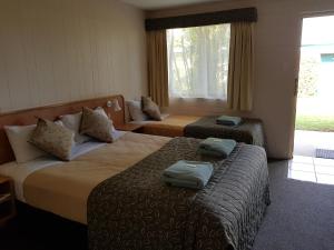 Postel nebo postele na pokoji v ubytování Peppercorn Motel