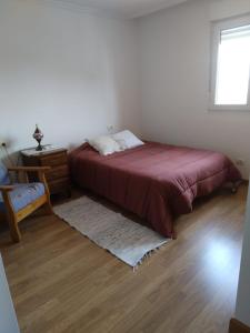 a bedroom with a bed and a table and a window at Ático Rosita en Camino de Santiago in Xinzo de Limia