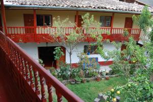 a balcony of a house with trees and plants at Hospedaje La Ñusta in Ollantaytambo