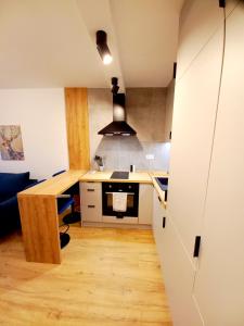 a small kitchen with a counter and a table at NeoApartments Lotnicza in Wrocław