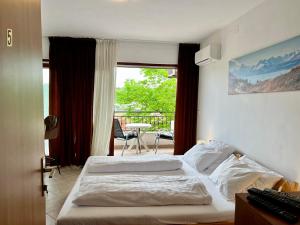 Postel nebo postele na pokoji v ubytování Rooms & Apartment Hegic