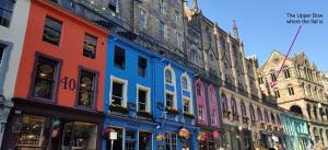 a row of colorful buildings on a street at Royal Mile Apartment, 1 minute from the castle. in Edinburgh