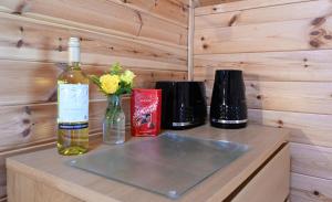 a bottle of wine sitting on a counter with two bottles of wine at Leven View Lodges - Callart in Fort William