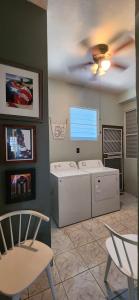 a laundry room with a washer and dryer and a ceiling fan at Kassa Wista Azzul-1 APARTMENT-NO POOL ACCESS-lower level OR Kassa Wista Azzul-2 House -upper floor- with EXCLUSIVE POOL ACCESS in Hormigueros