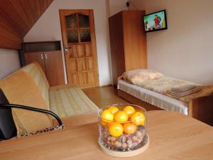 a living room with a bowl of oranges on a table at holiday home, Pobierowo in Pobierowo