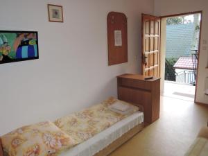 a room with a bed and a dresser and a television at holiday home, Pobierowo in Pobierowo