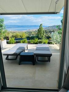 a balcony with two benches and a view of the city at CASA LC chambre1 vue Mer Jacuzzi in Ajaccio