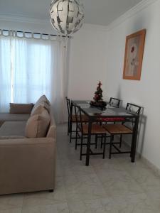 Sala de estar con sofá y mesa con árbol de Navidad en Apartamento vacacional en Orzola Lanzarote, en Orzola