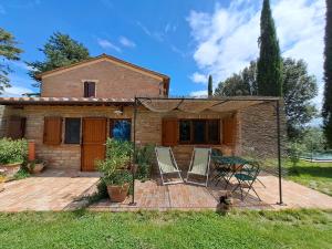 a house with two chairs and a table on a deck at Agriturismo La Casetta del Sole in Villastrada
