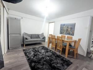 a kitchen and dining room with a table and a couch at Charming 4-Bedroom House in Dover in Dover