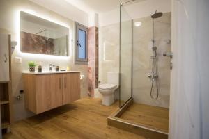 a bathroom with a shower and a toilet and a sink at Vonitsa Luxury Apartments in Vonitsa