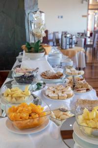 a long table with plates of food on it at Gran Hotel Vicente Costanera in Puerto Montt
