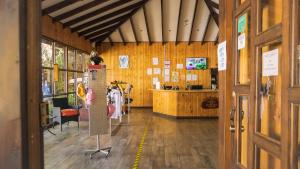 a room with a store with wooden walls and a door at Hotel de Montaña Suria in San Gerardo de Dota
