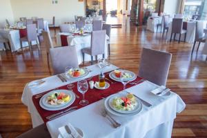 a table with plates of food and wine glasses at Gran Hotel Vicente Costanera in Puerto Montt +45 photos