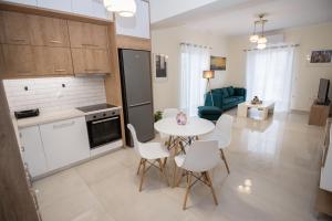 a kitchen and living room with a table and chairs at Vonitsa Luxury Apartments in Vonitsa