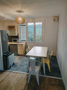 a kitchen with a table and chairs in a room at Maison 6 chambres avec jardin à Angers in Angers