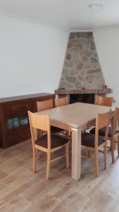 a dining room table and chairs with a fireplace at VILLA ALTO DE LOS BALCONES Torrevieja - Orihuela Costa in Orihuela +12 photos