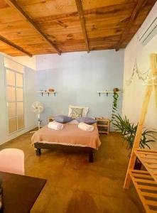 sypialnia z łóżkiem w pokoju z drewnianym sufitem w obiekcie La Punta Beach House w mieście Puerto Escondido