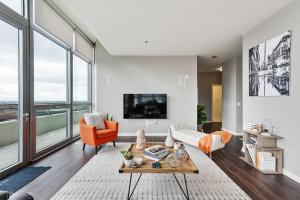 a living room with a couch and a tv at Penthouses near Fulton Market-Cloud9-365 in Chicago