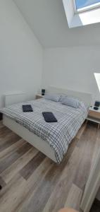 a bedroom with a bed with two pillows on it at Duplex proche de Genève et du lac léman in Veigy-Foncenex