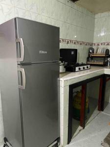 a kitchen with a stainless steel refrigerator and a stove at La Casa votre hébergement idéal in Dakhla
