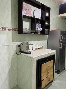 eine Küche mit einer Theke und einem Kühlschrank in der Unterkunft La Casa votre hébergement idéal in Ad-Dakhla