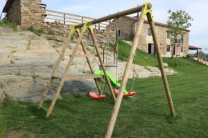 a playground with a swing set in a yard at O lar de san fins in A Coruña
