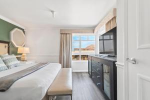 ein Hotelzimmer mit einem Bett und einem Fenster in der Unterkunft Ascot Suites Morro Bay in Morro Bay