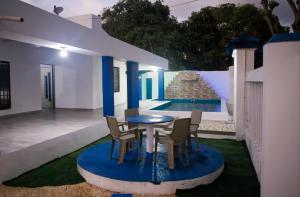a patio with a table and chairs and a pool at Cabaña Perla Azul in Coveñas