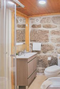 a stone bathroom with a sink and a toilet at Retiro de Várzeas . Casa de Turismo Rural in Vieira do Minho